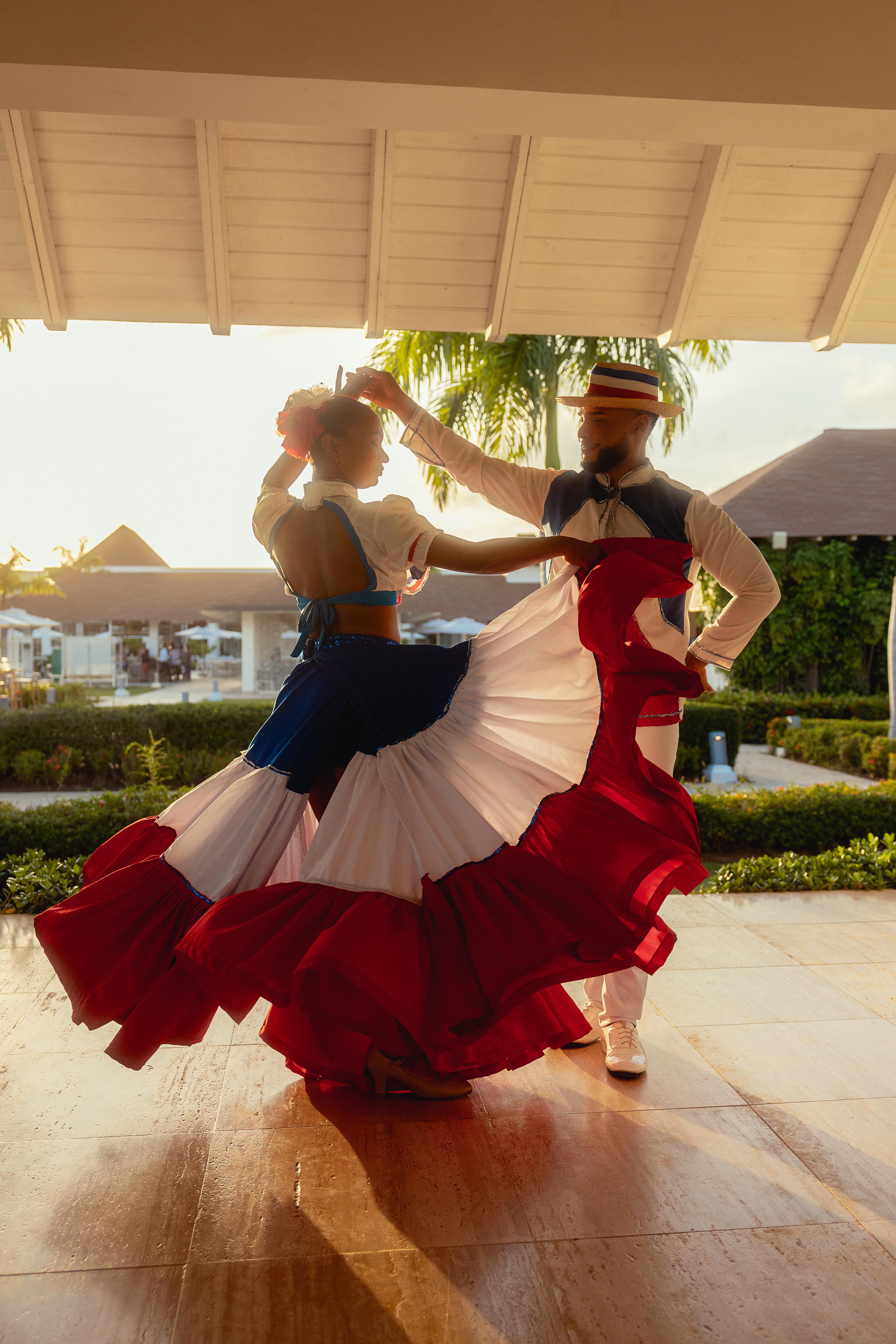 a man and woman dancing in a red white and blue dress