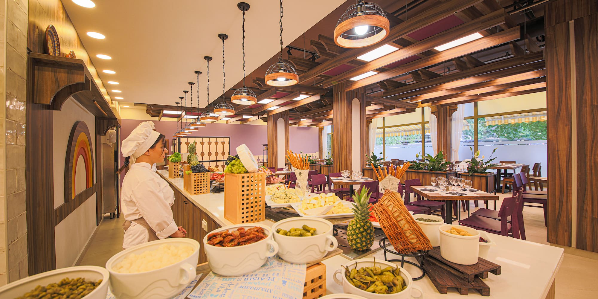 a woman in a chef's hat standing in a restaurant