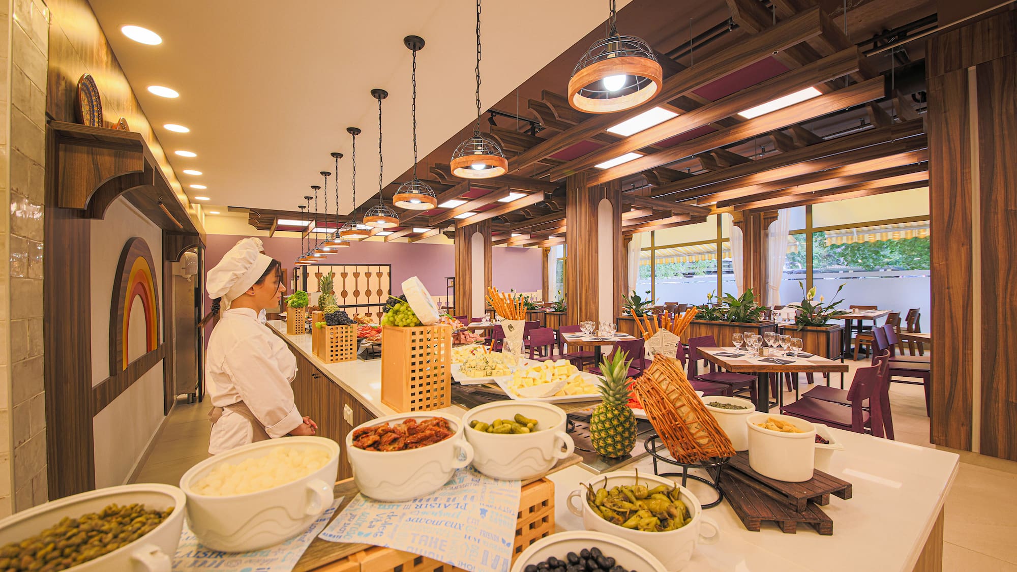 a woman in a chef's hat standing in a restaurant