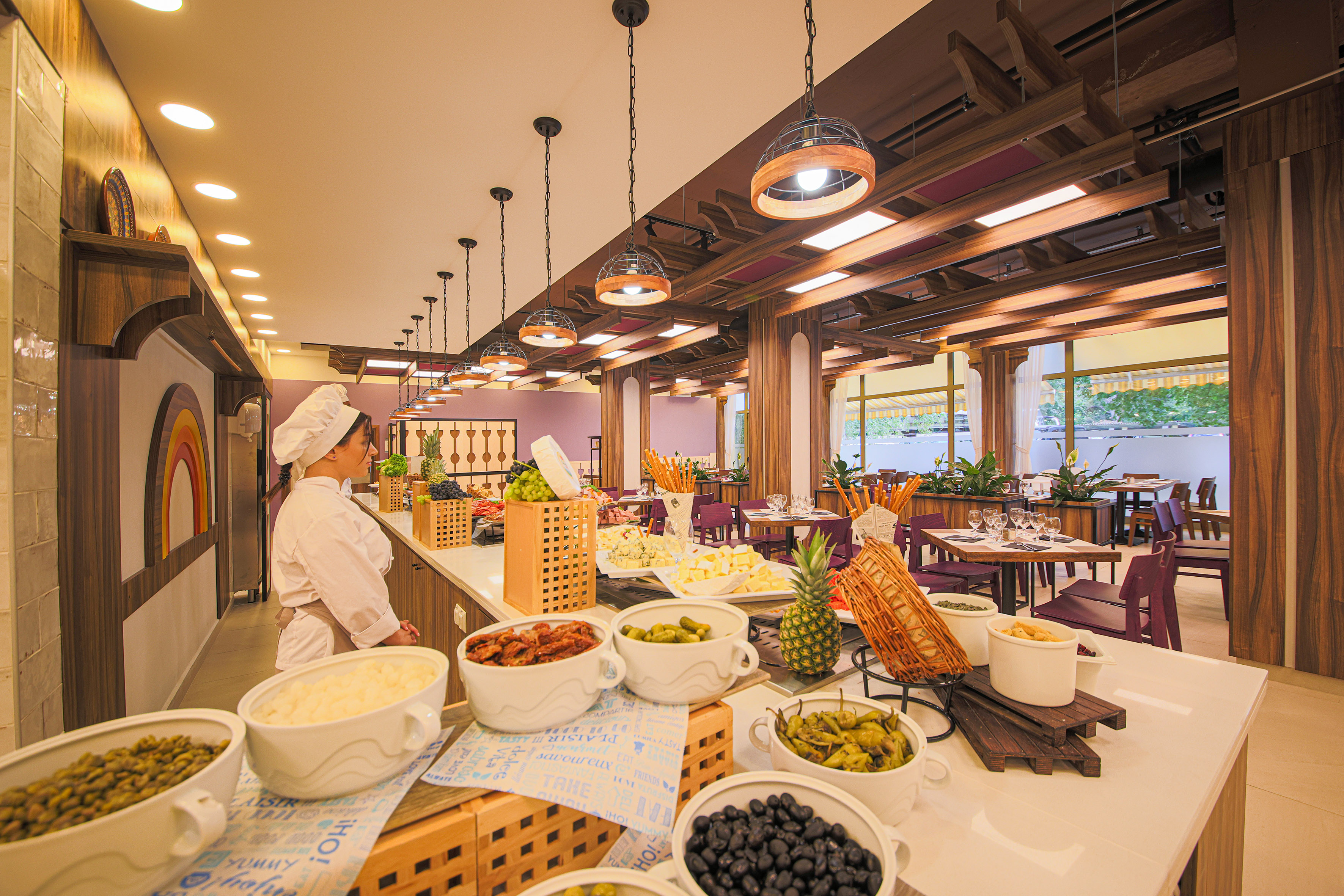 a woman in a chef's hat standing in a restaurant
