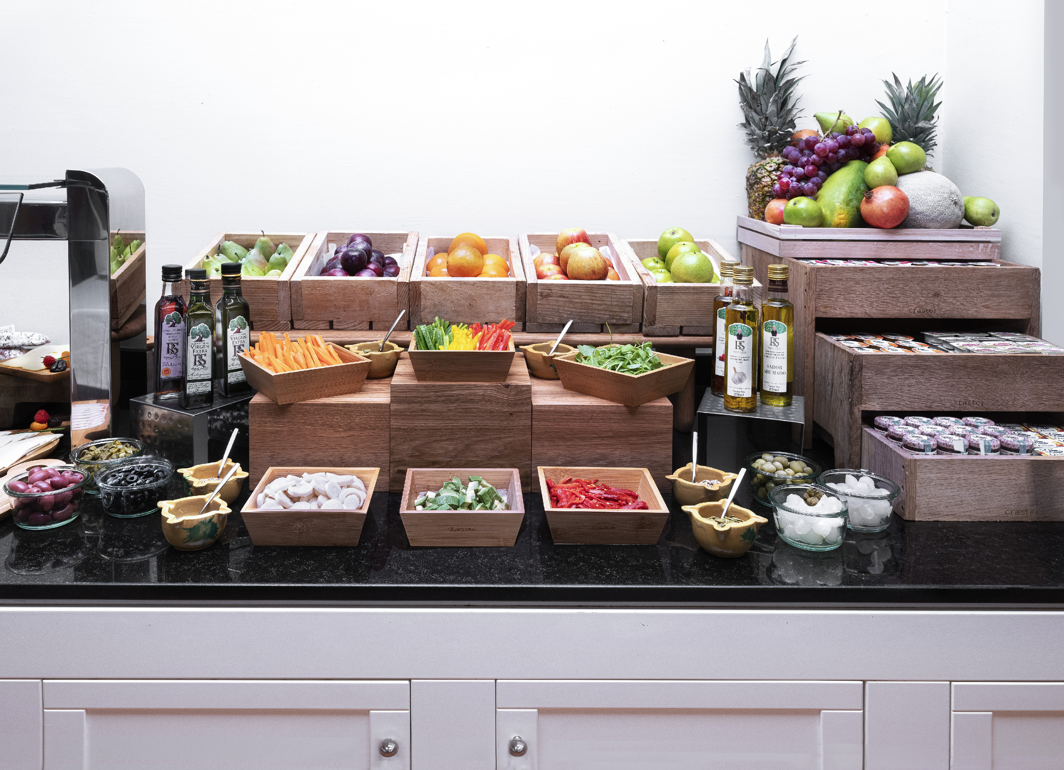 Fresh fruit and vegetable buffet with olive oil, healthy toppings, and gourmet selections.