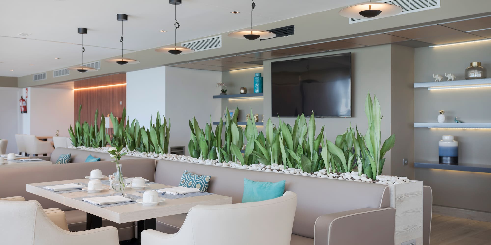 a room with a table and chairs and a television