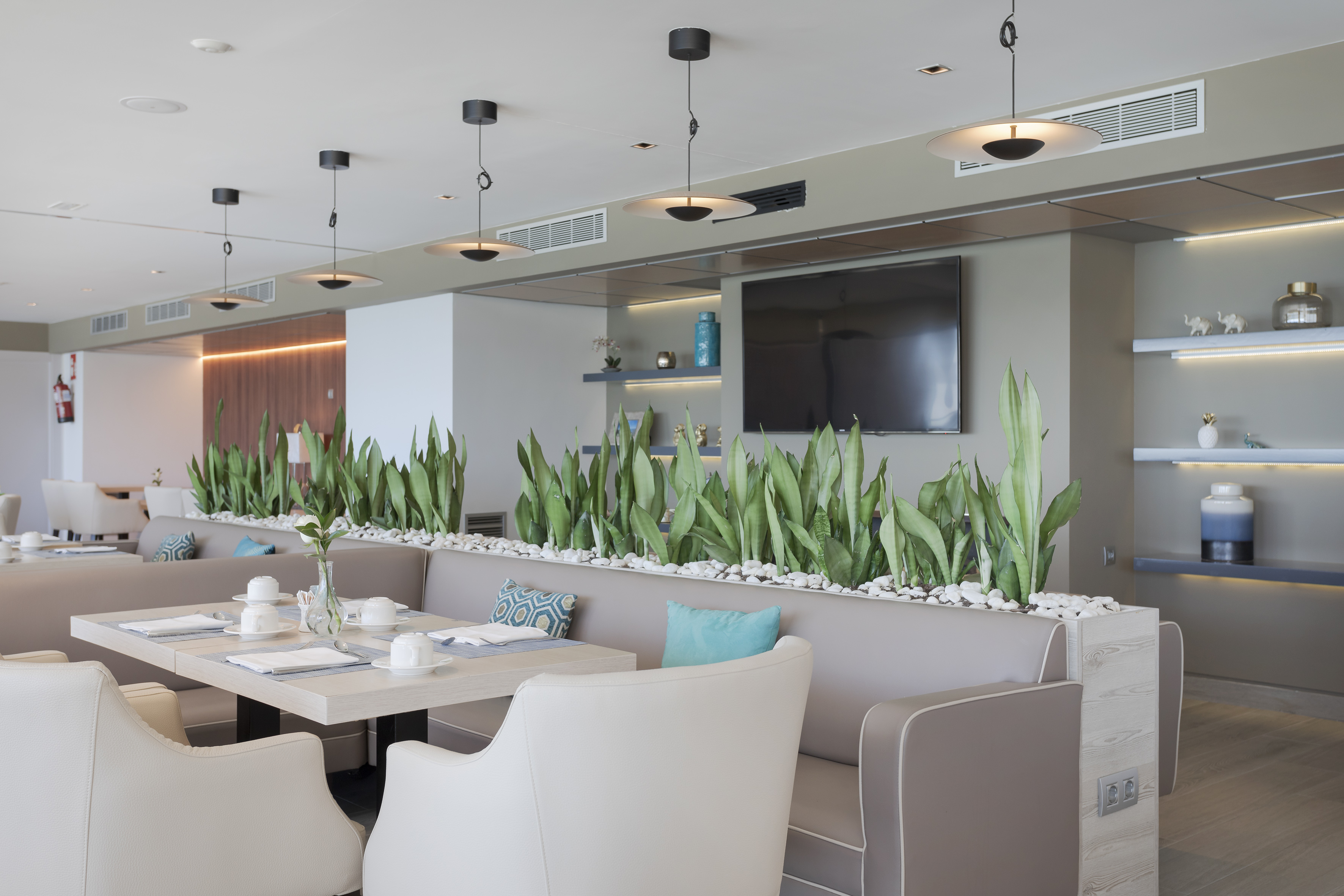 a room with a table and chairs and a television