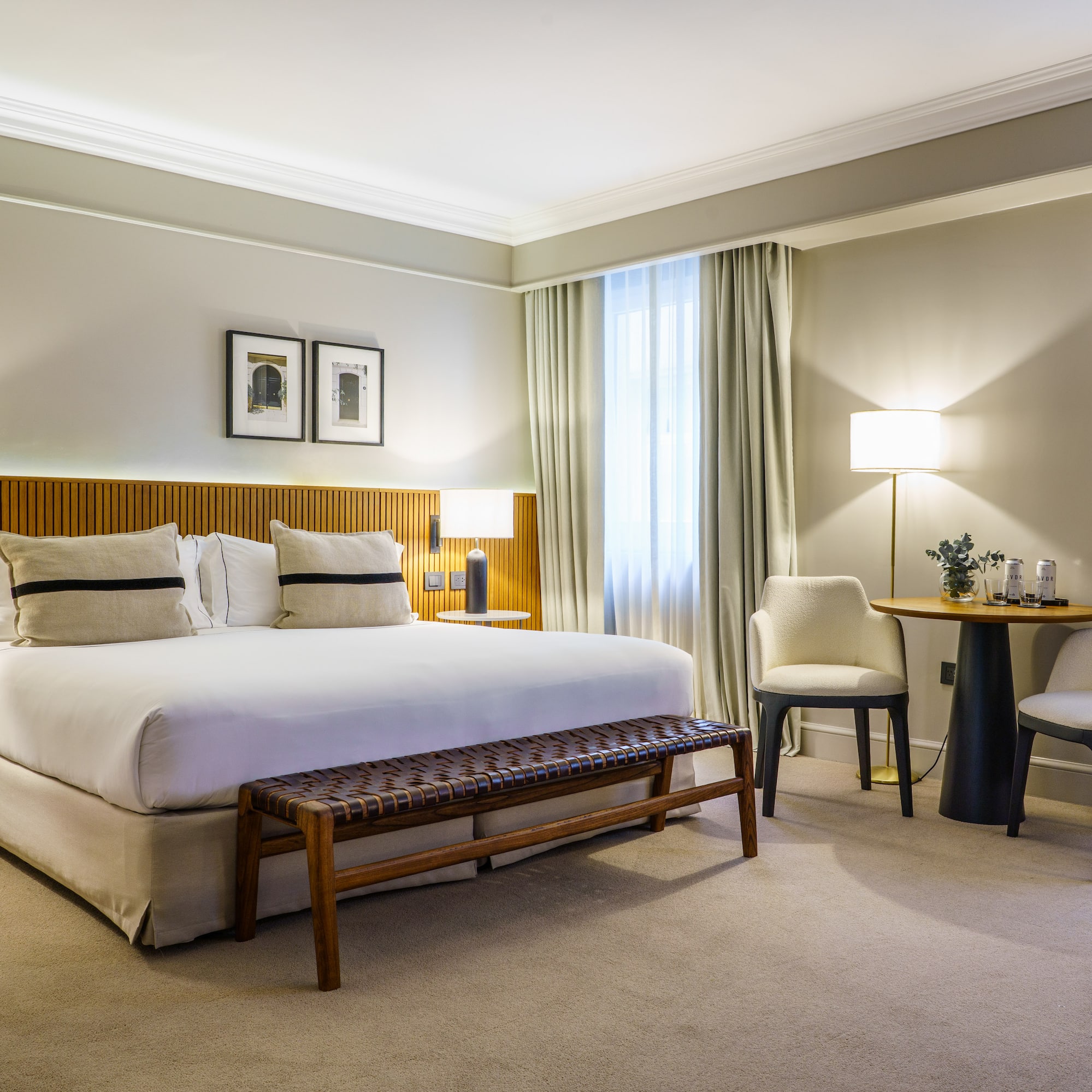 a bedroom with a bed and chairs