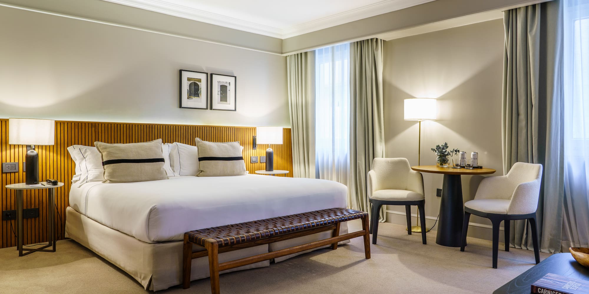 a bedroom with a bed and chairs