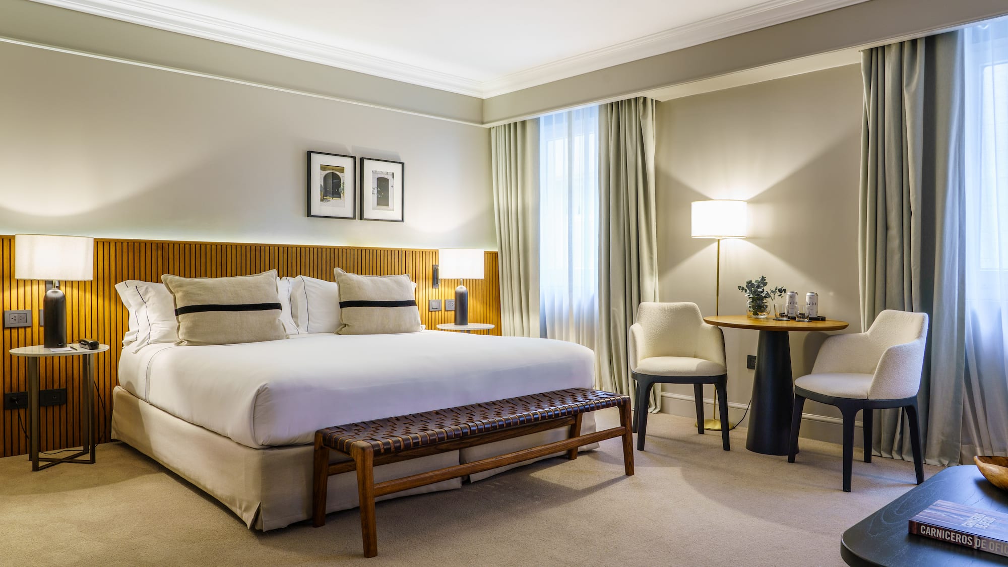 a bedroom with a bed and chairs