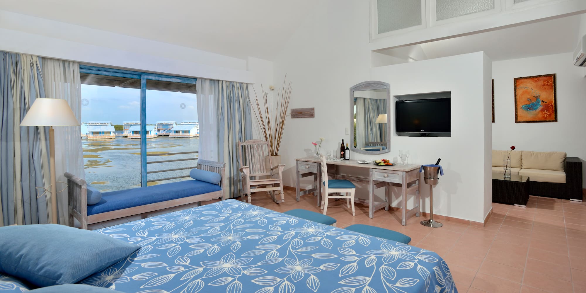 a room with a bed and a television