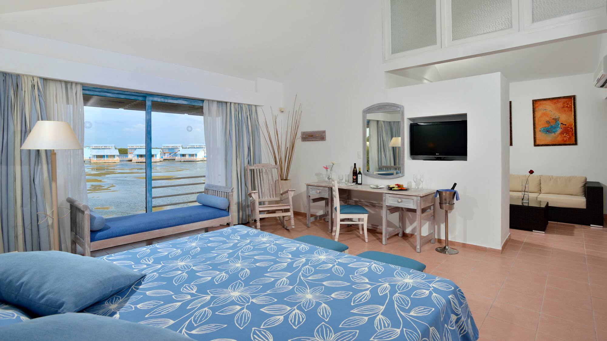 a room with a bed and a television