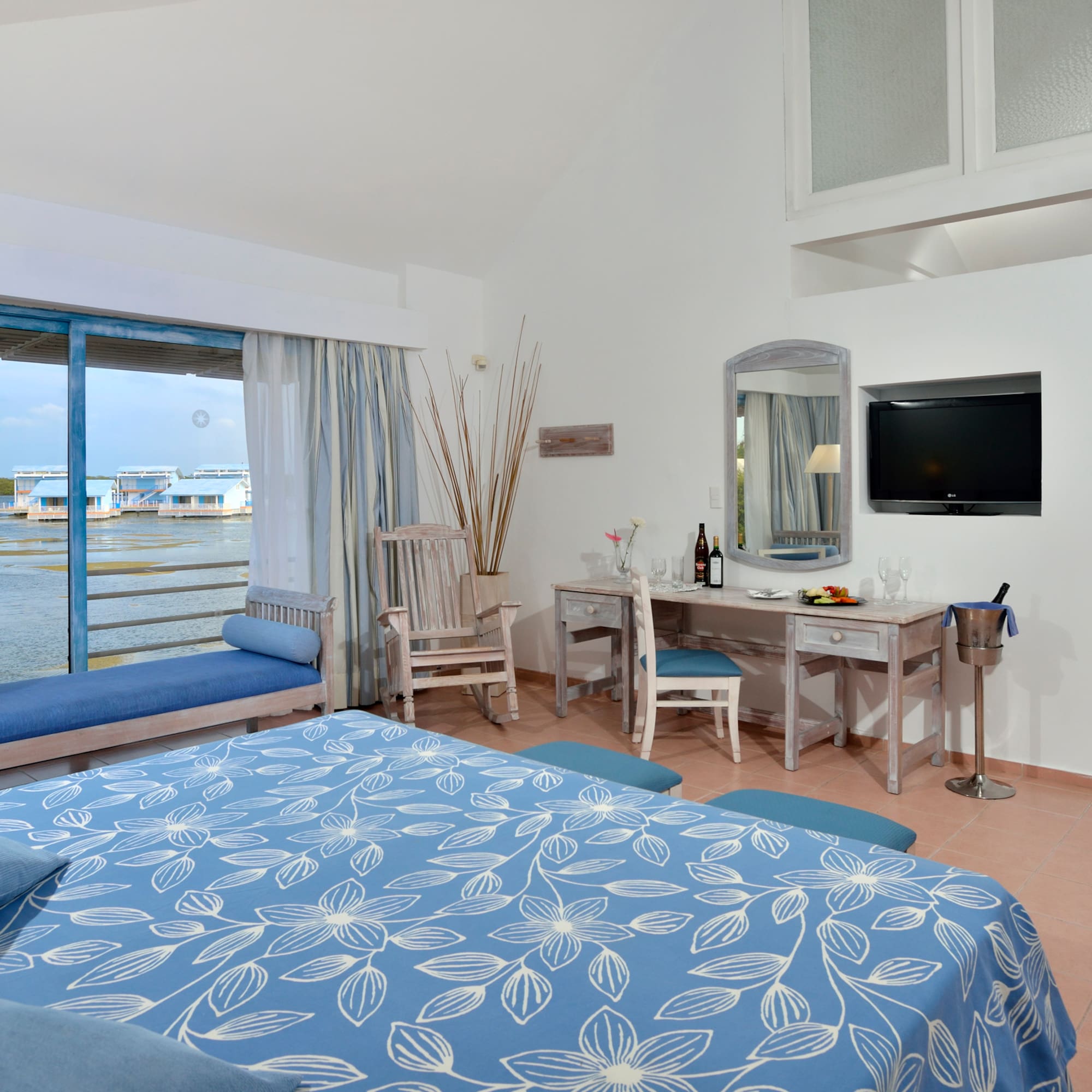 a room with a bed and a television