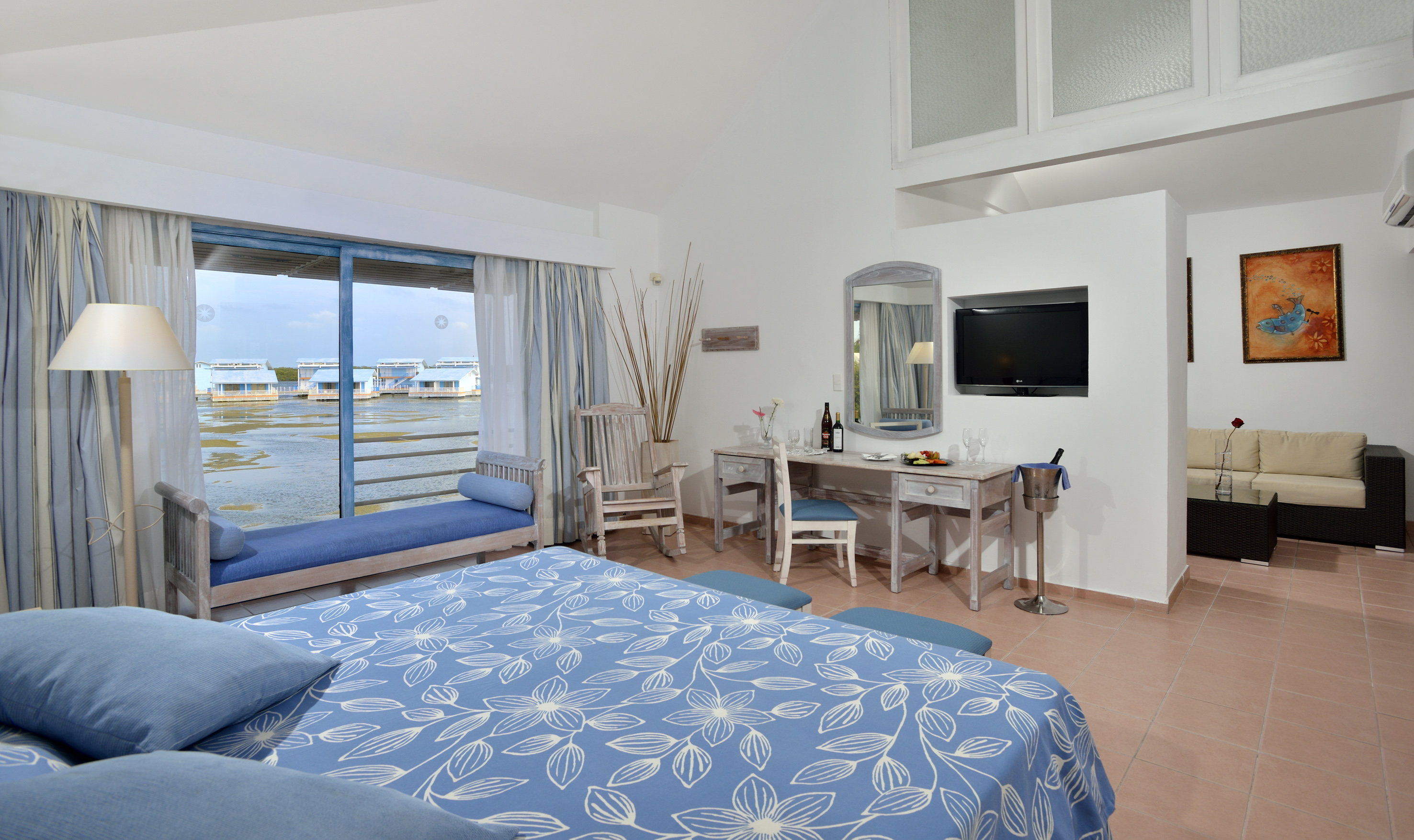a room with a bed and a television