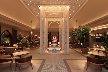 a room with a fountain and tables and chairs