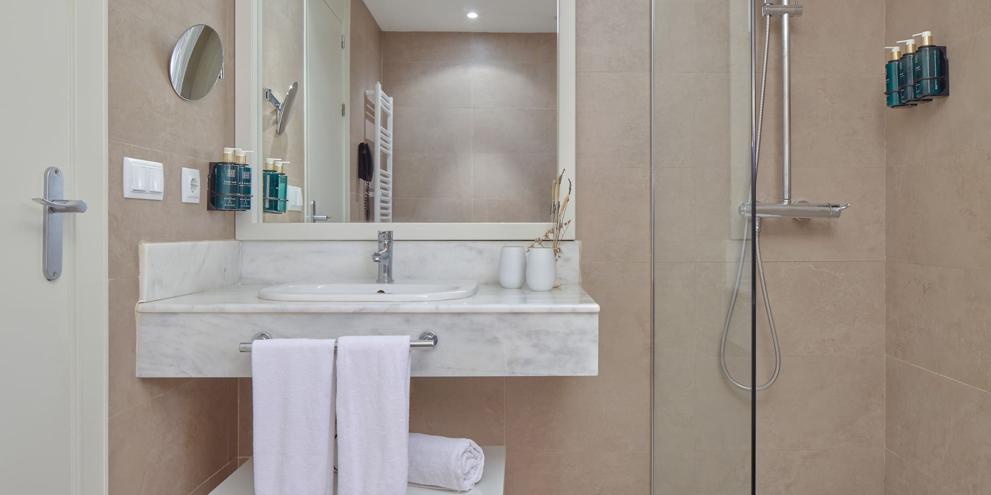 a bathroom with a shower and a sink