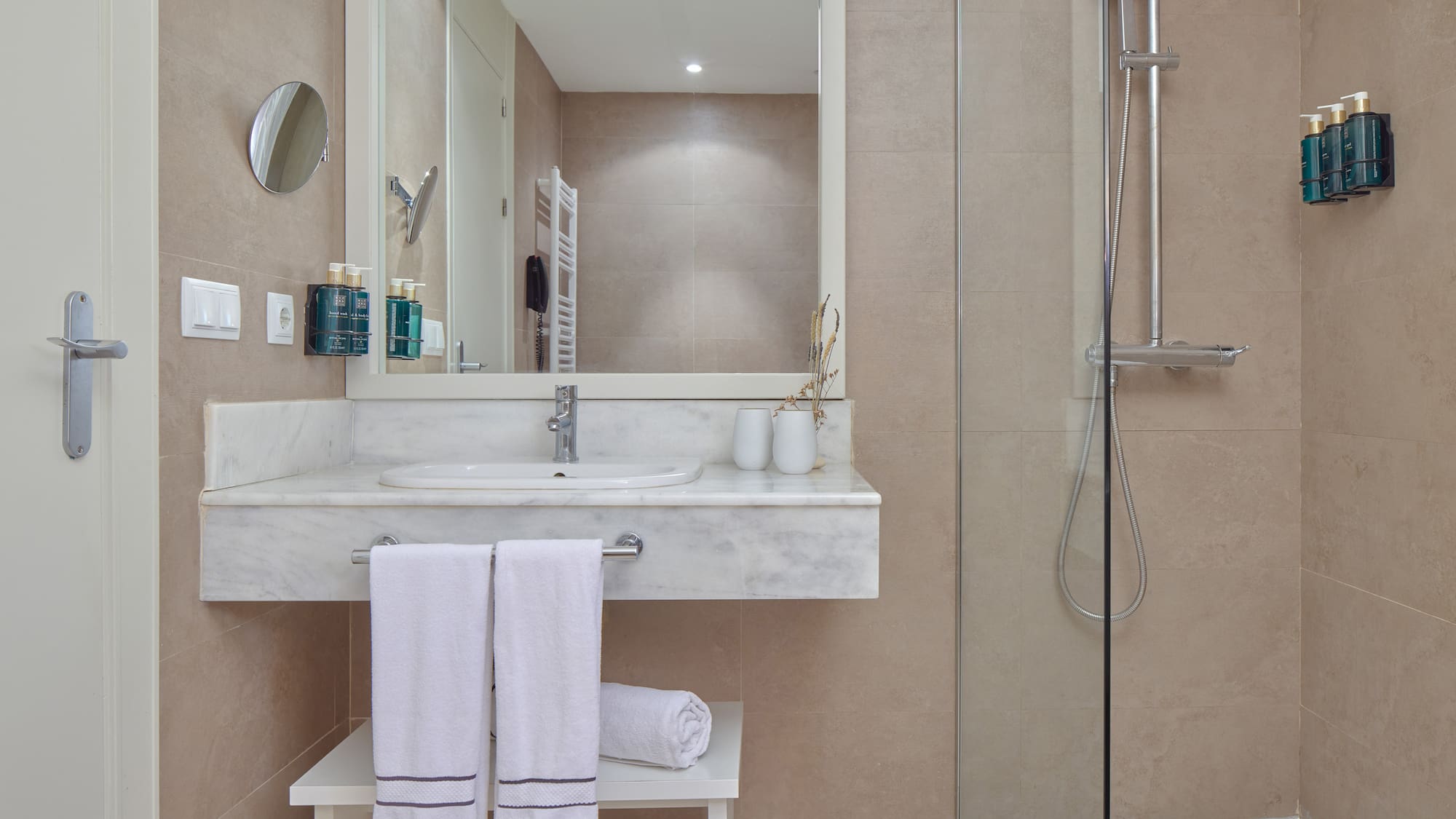 a bathroom with a shower and a sink