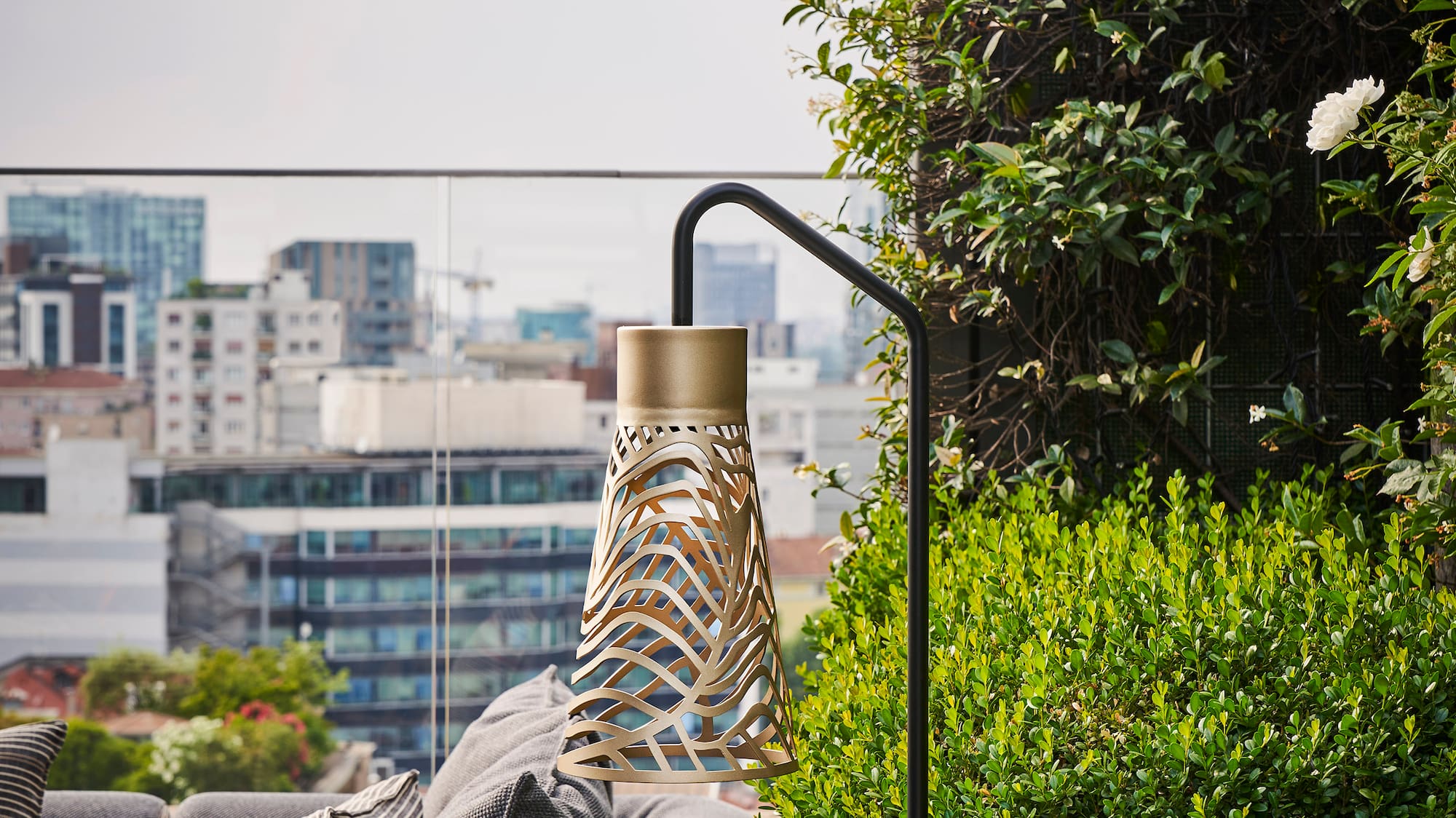 a balcony with a couch and plants