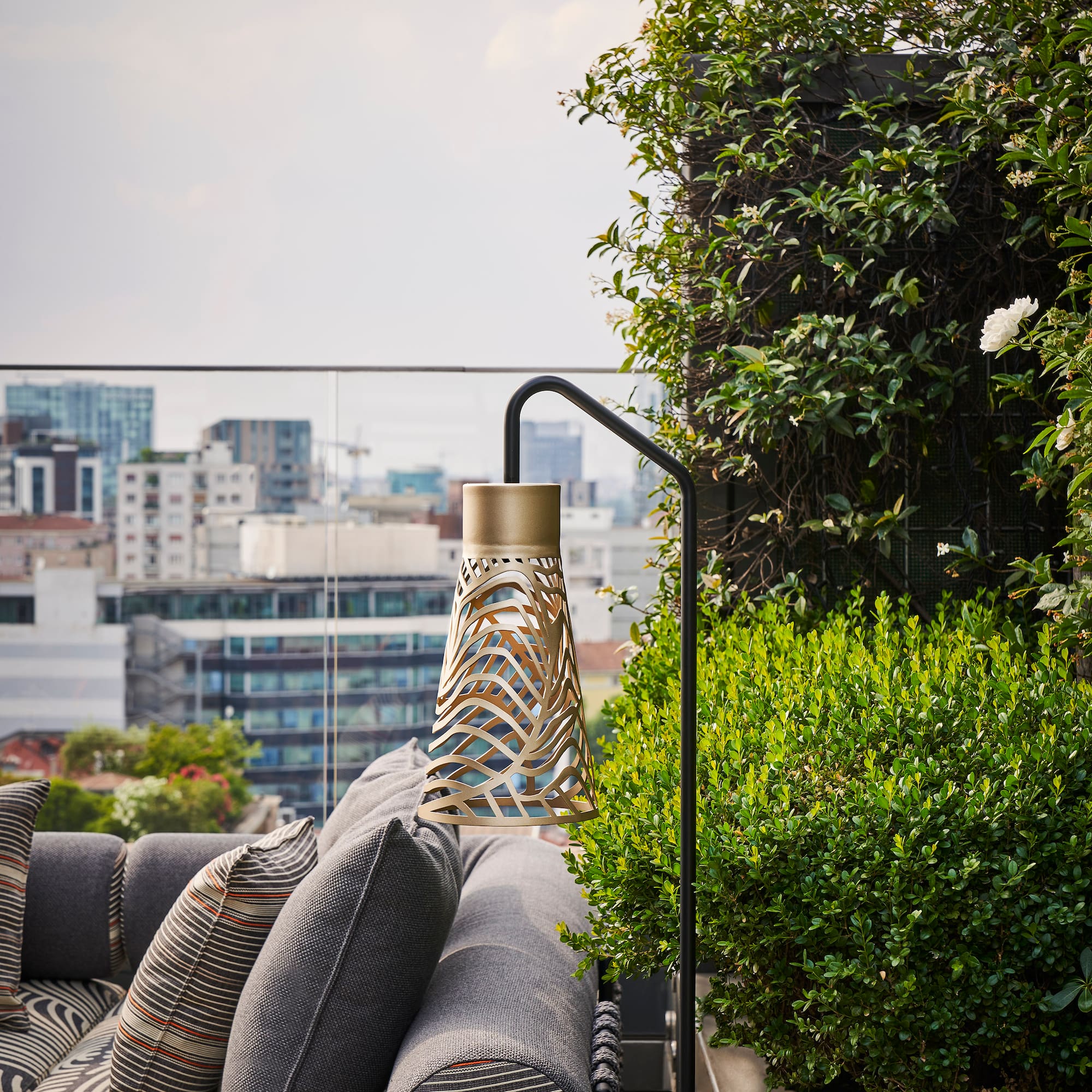 a balcony with a couch and plants