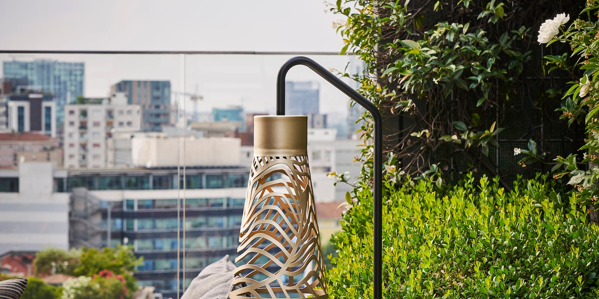 a balcony with a couch and plants