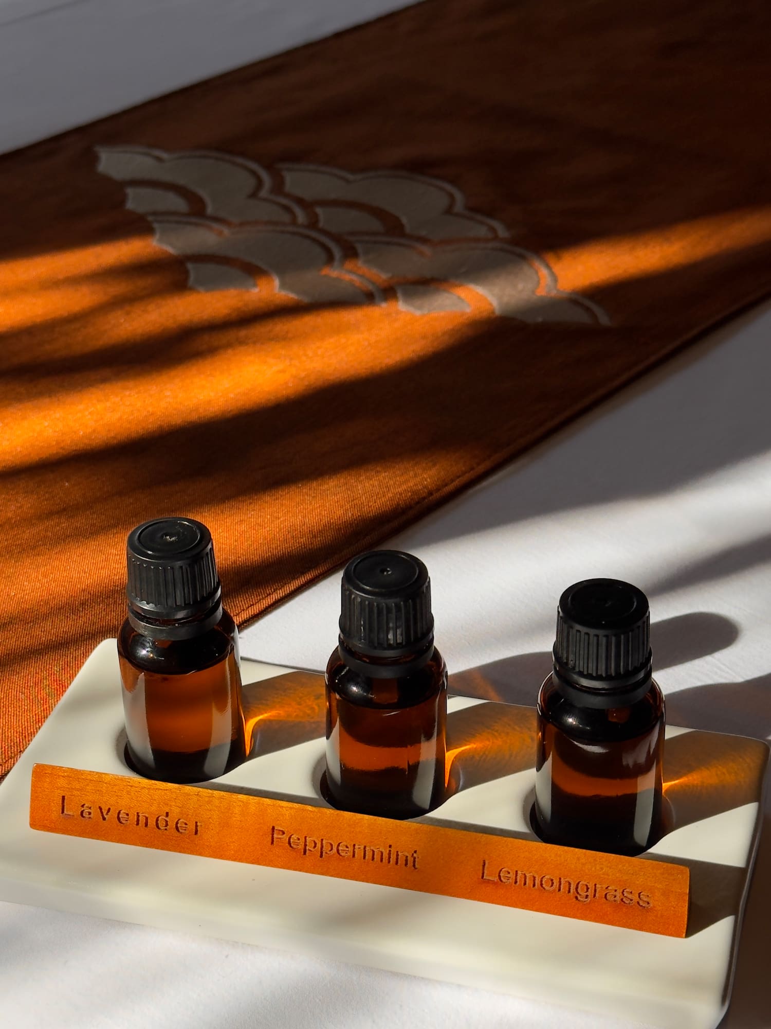 Lavender, Peppermint, Lemongrass essential oil bottles in a white holder.