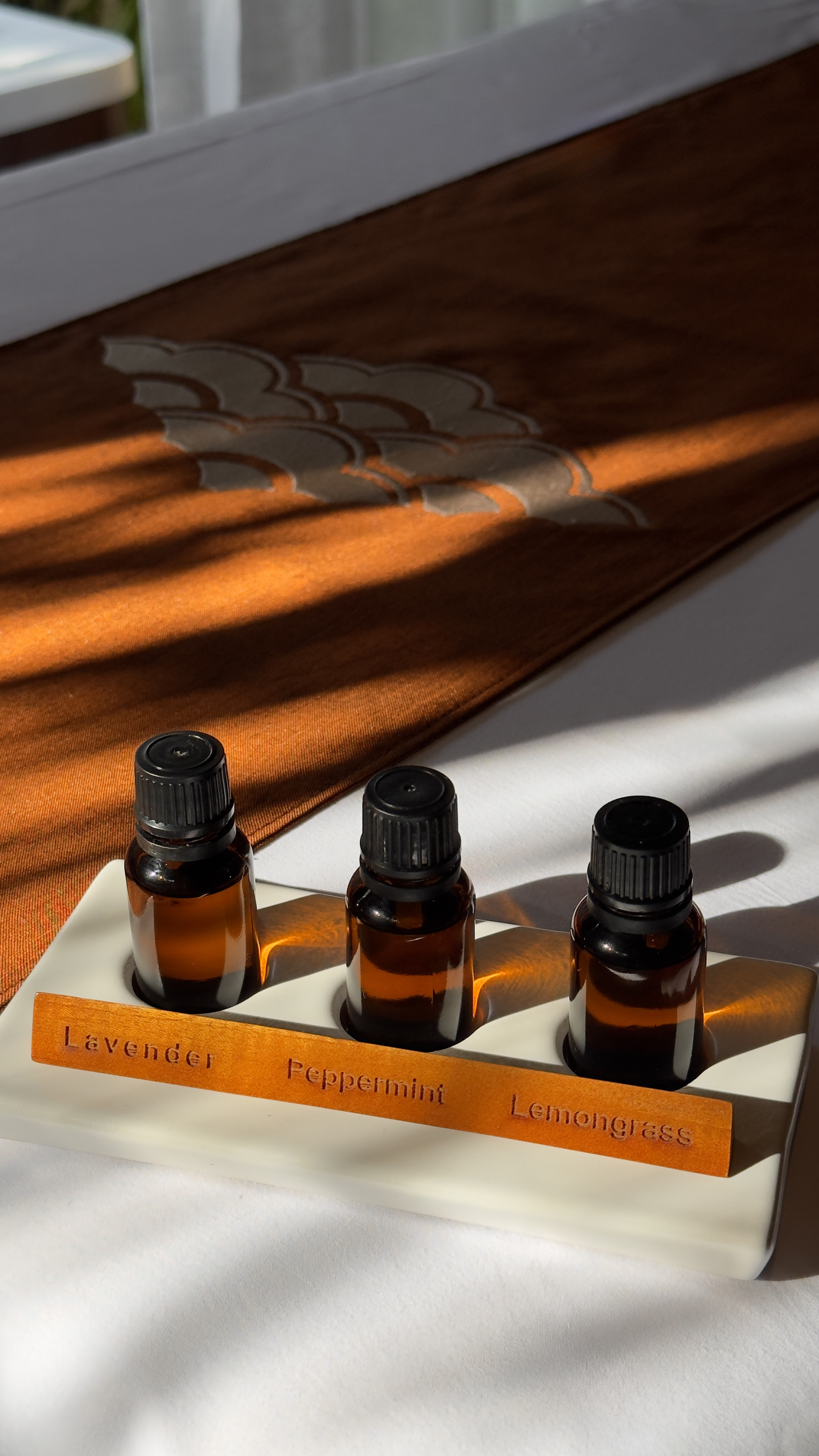 Lavender, Peppermint, Lemongrass essential oil bottles in a white holder.