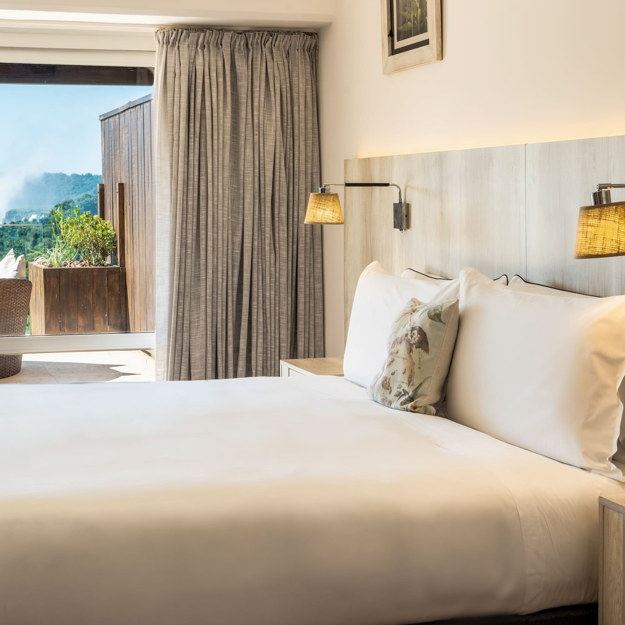 a bed with pillows and lamps in a room