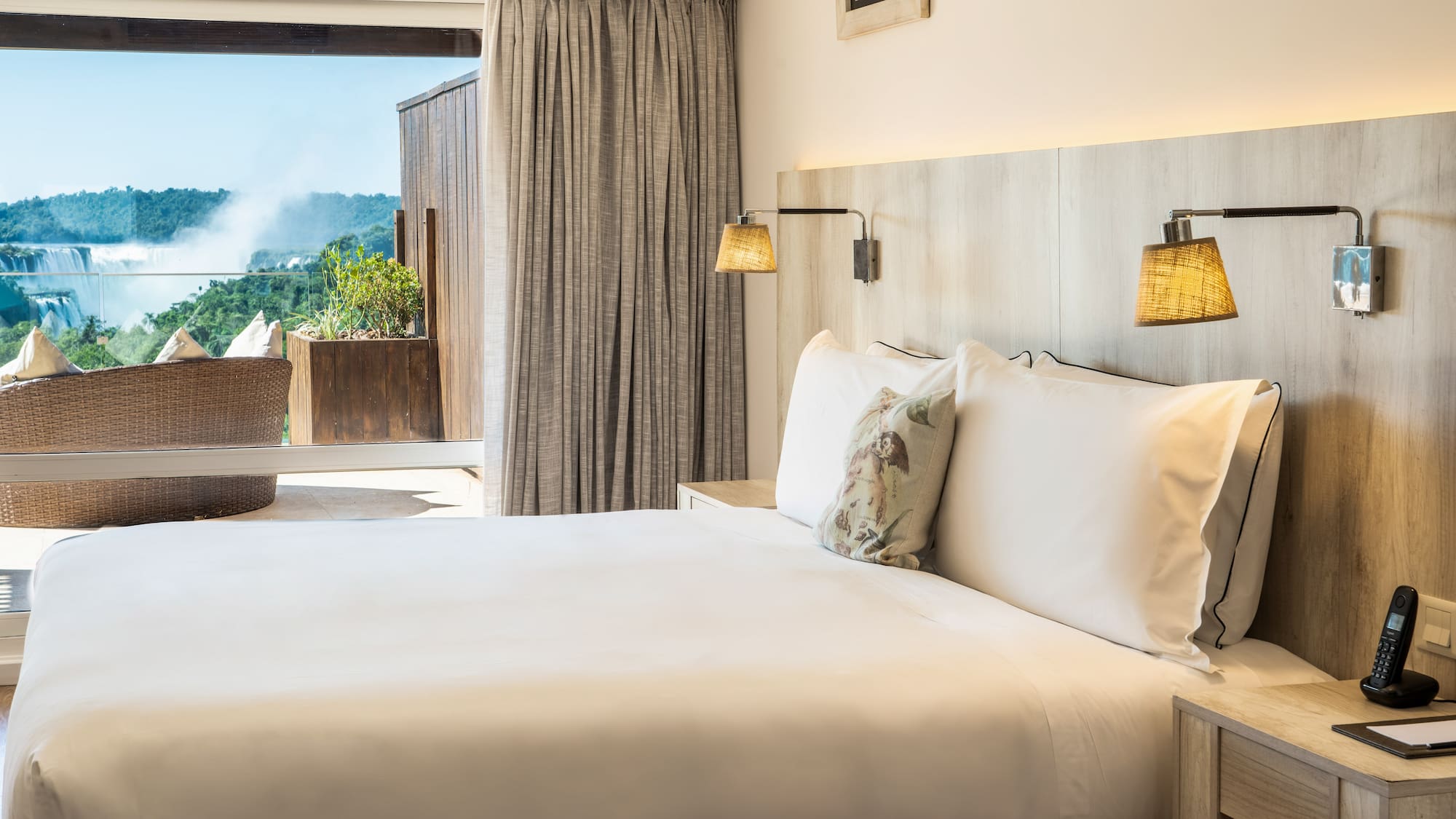 a bed with pillows and lamps in a room