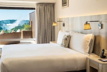 a bed with pillows and lamps in a room