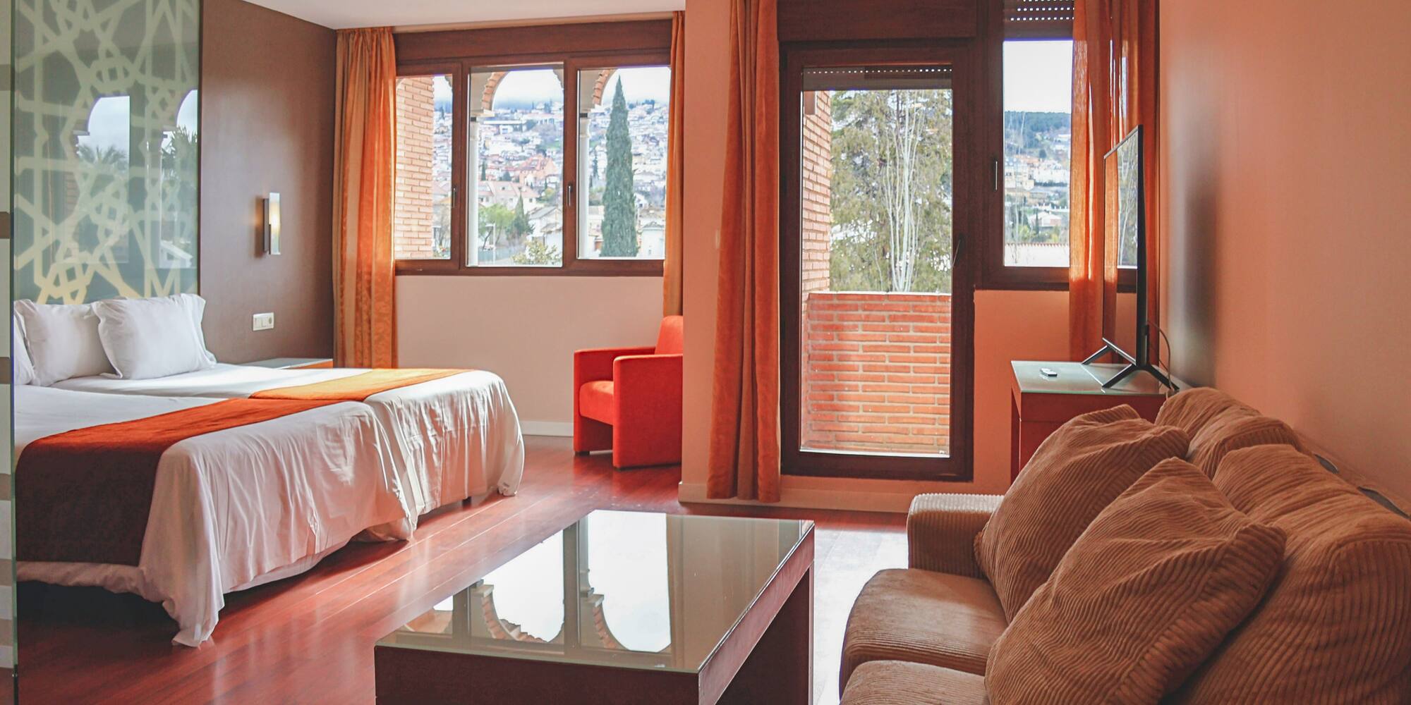 a room with a bed and couches