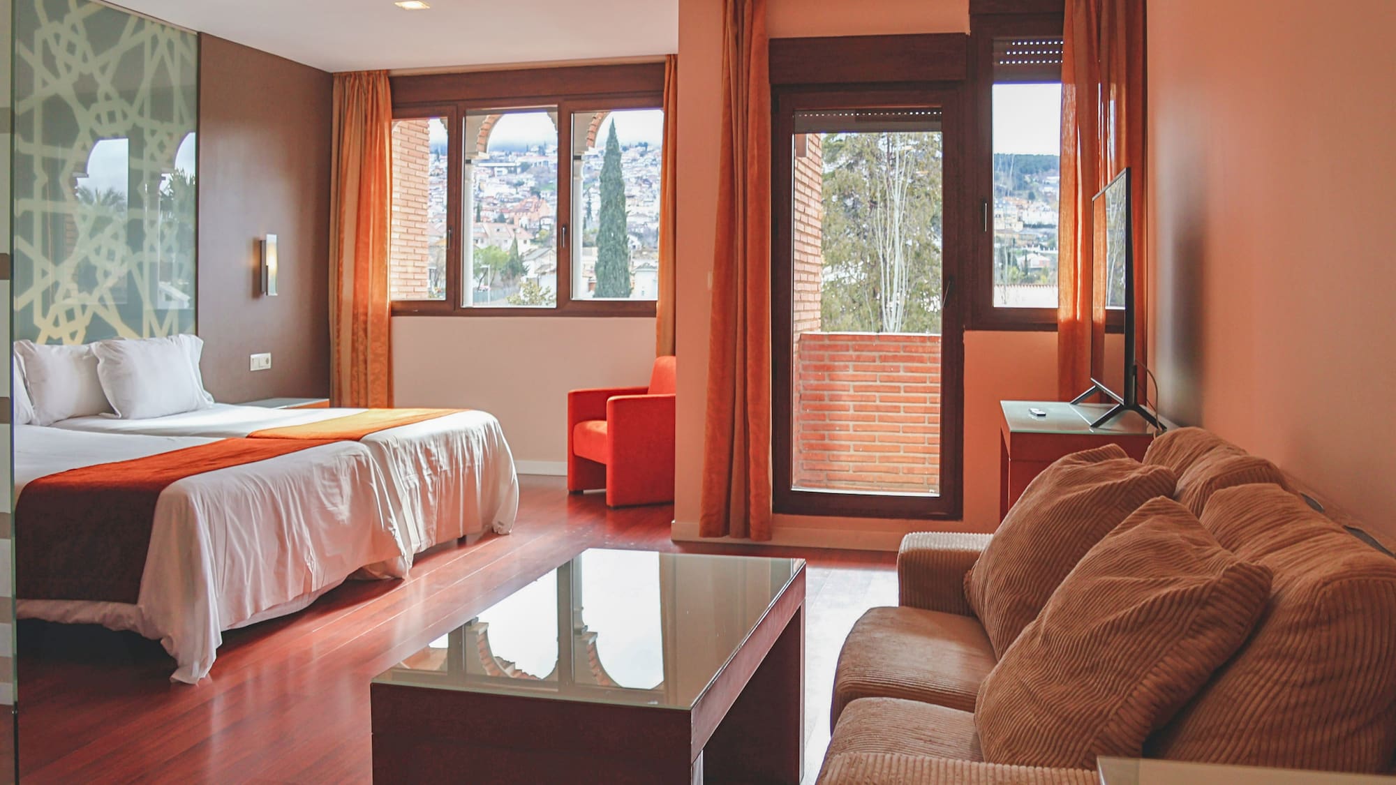 a room with a bed and couches