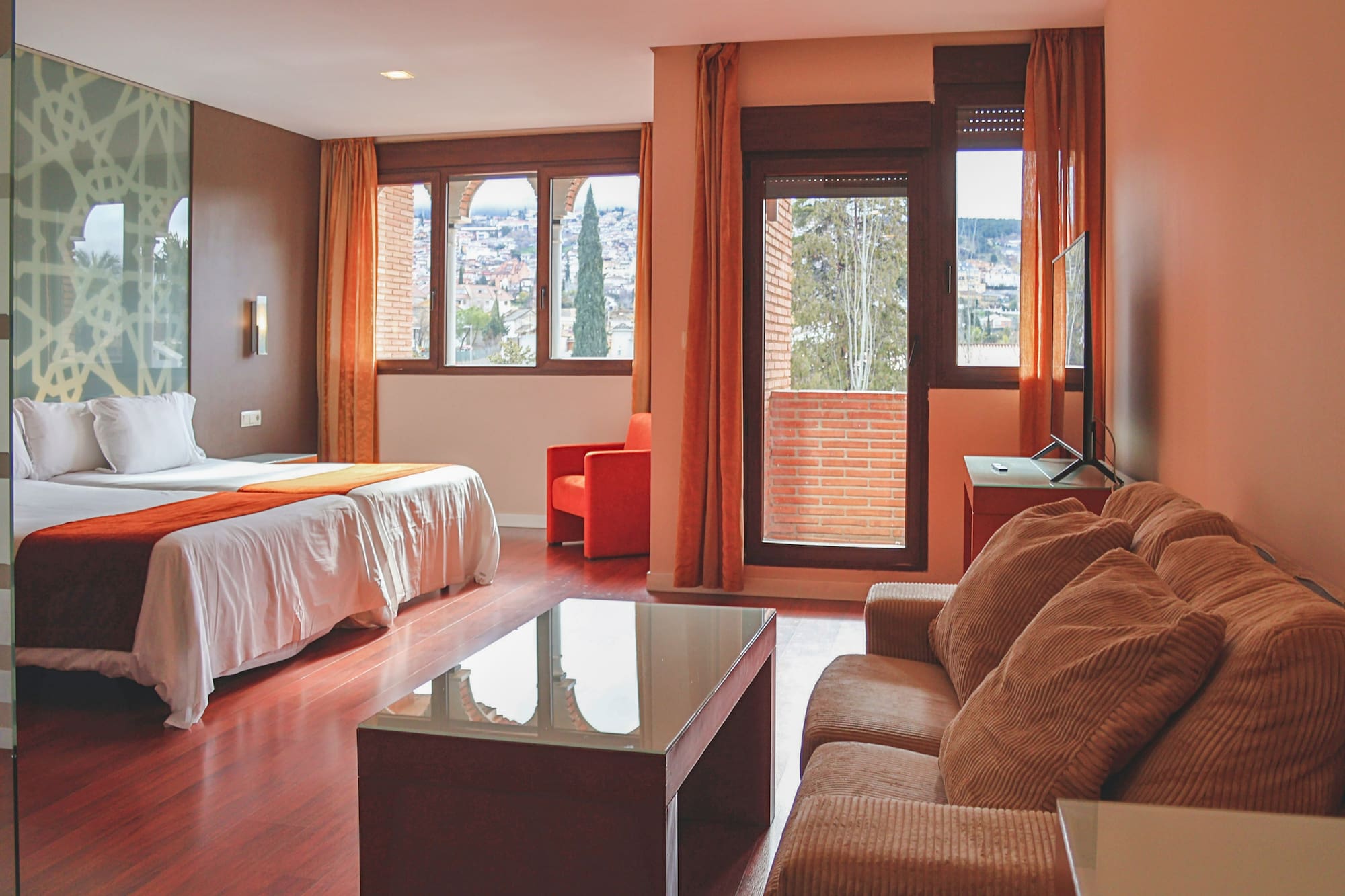 a room with a bed and couches