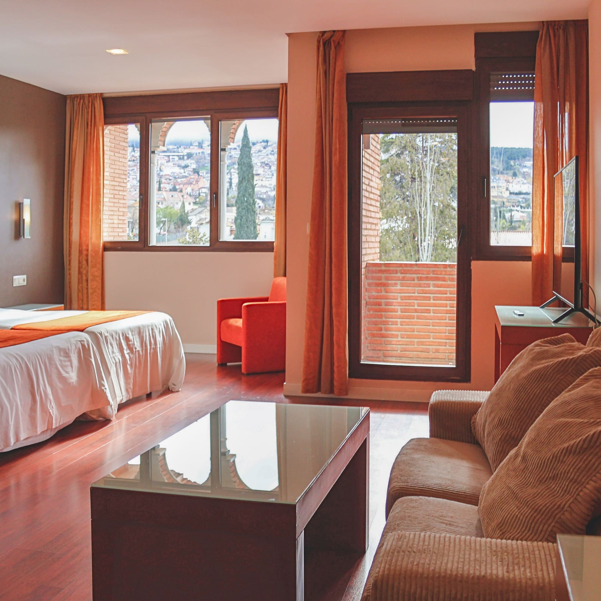 a room with a bed and couches