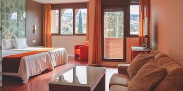 a room with a bed and couches