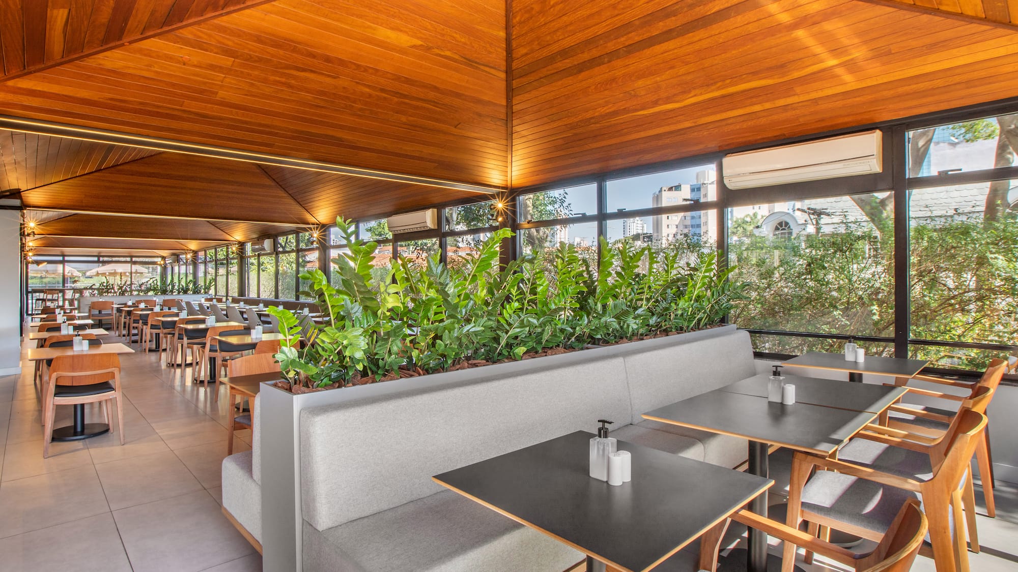 a room with tables and chairs and plants