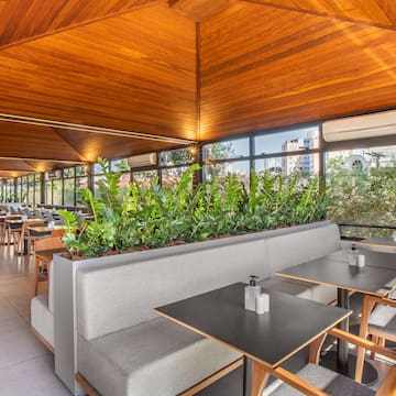 a room with tables and chairs and plants