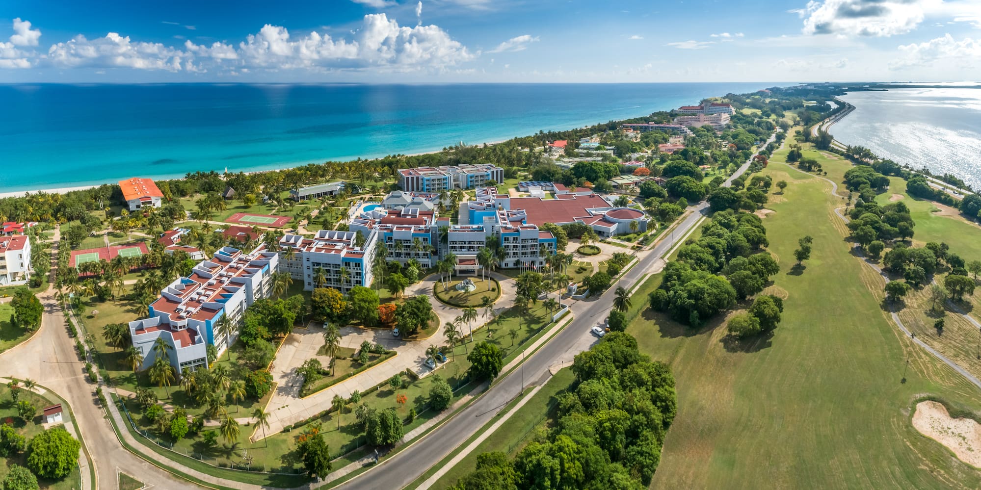 a aerial view of a beach with buildings and trees