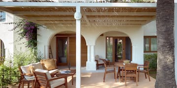 a patio with a covered patio and chairs