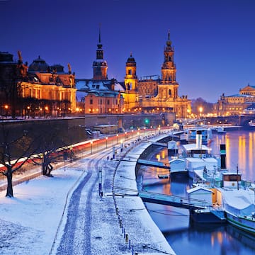 a city with a river and a bridge and a boat