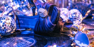 a blue shoe on a record with disco balls and a disco ball