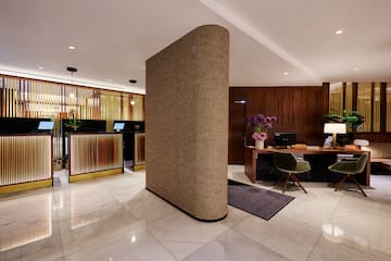 a room with a large column and a desk and computer