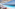 Luxury resort infinity pool with stunning sea view, lounge chairs, umbrellas.