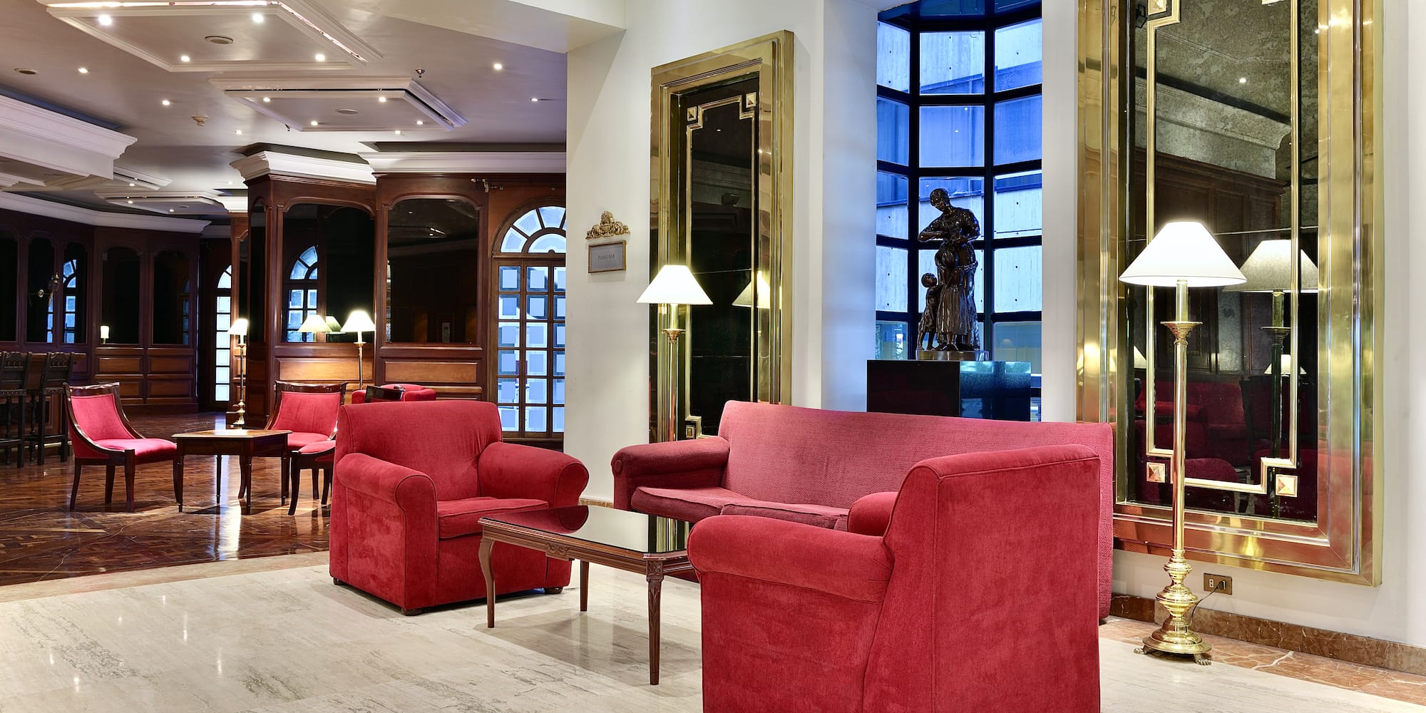 a room with red couches and chairs