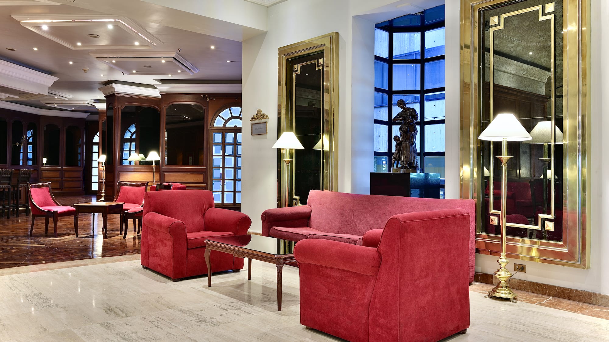 a room with red couches and chairs