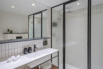 a bathroom with a shower and sink