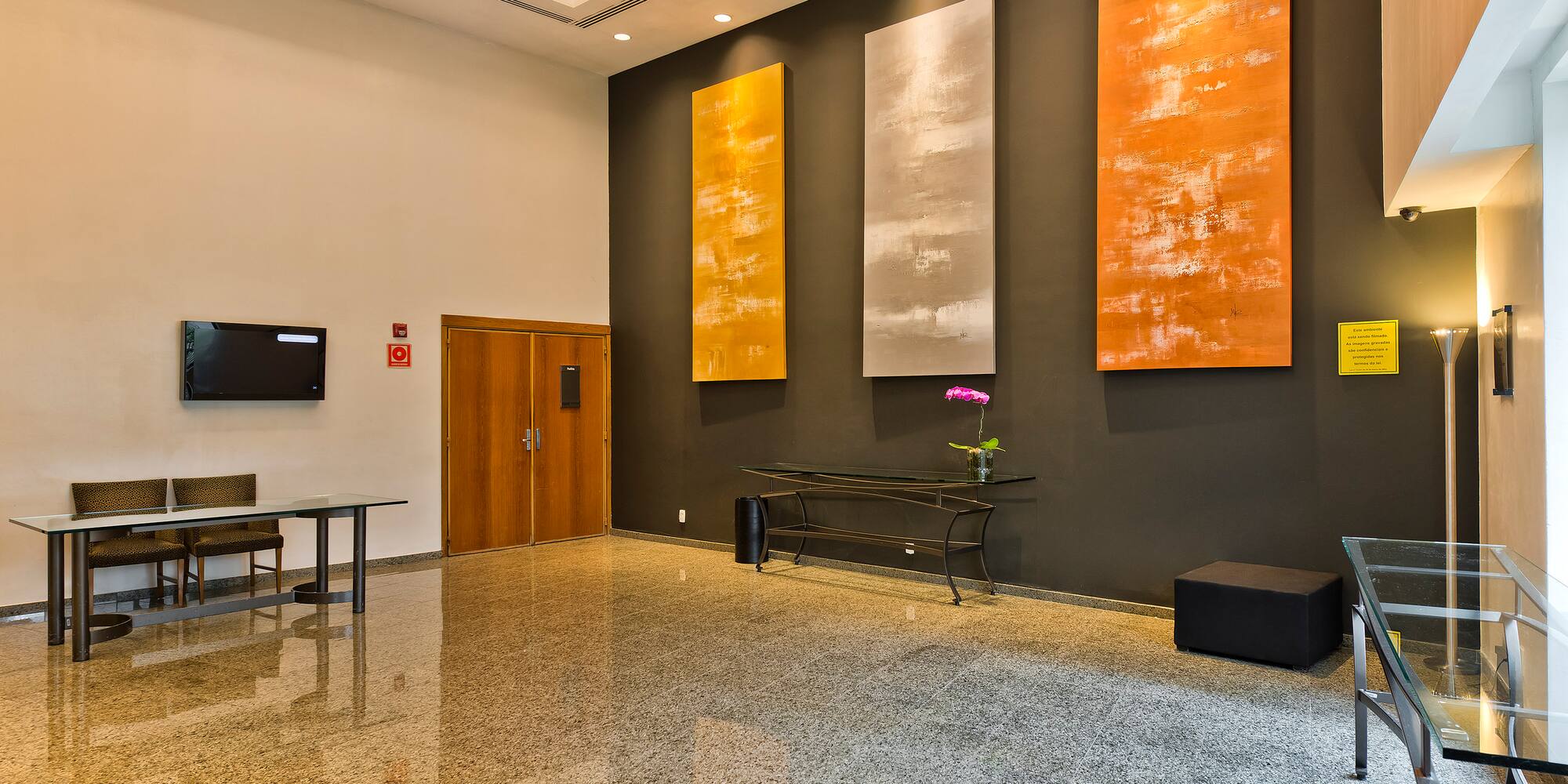 a room with a table and chairs and art on the wall