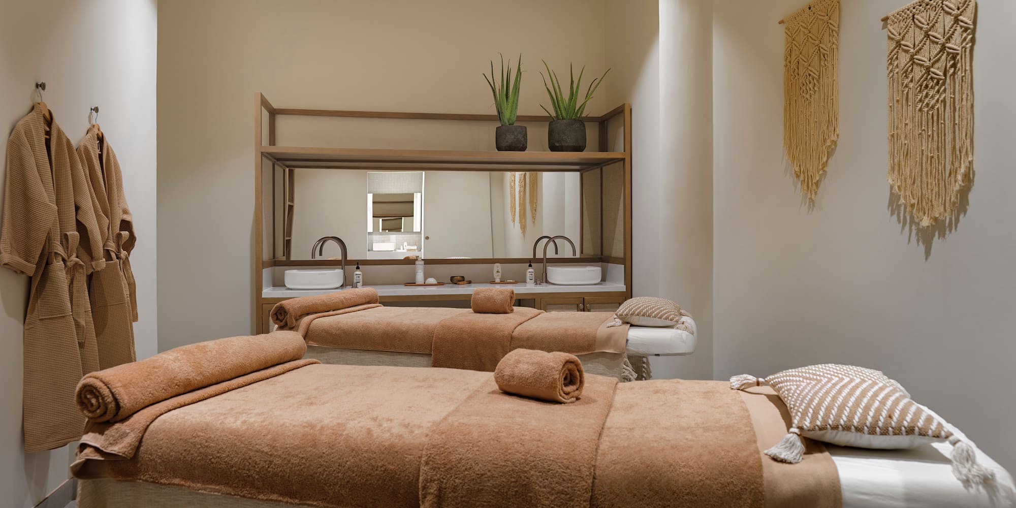 a room with two beds and a mirror