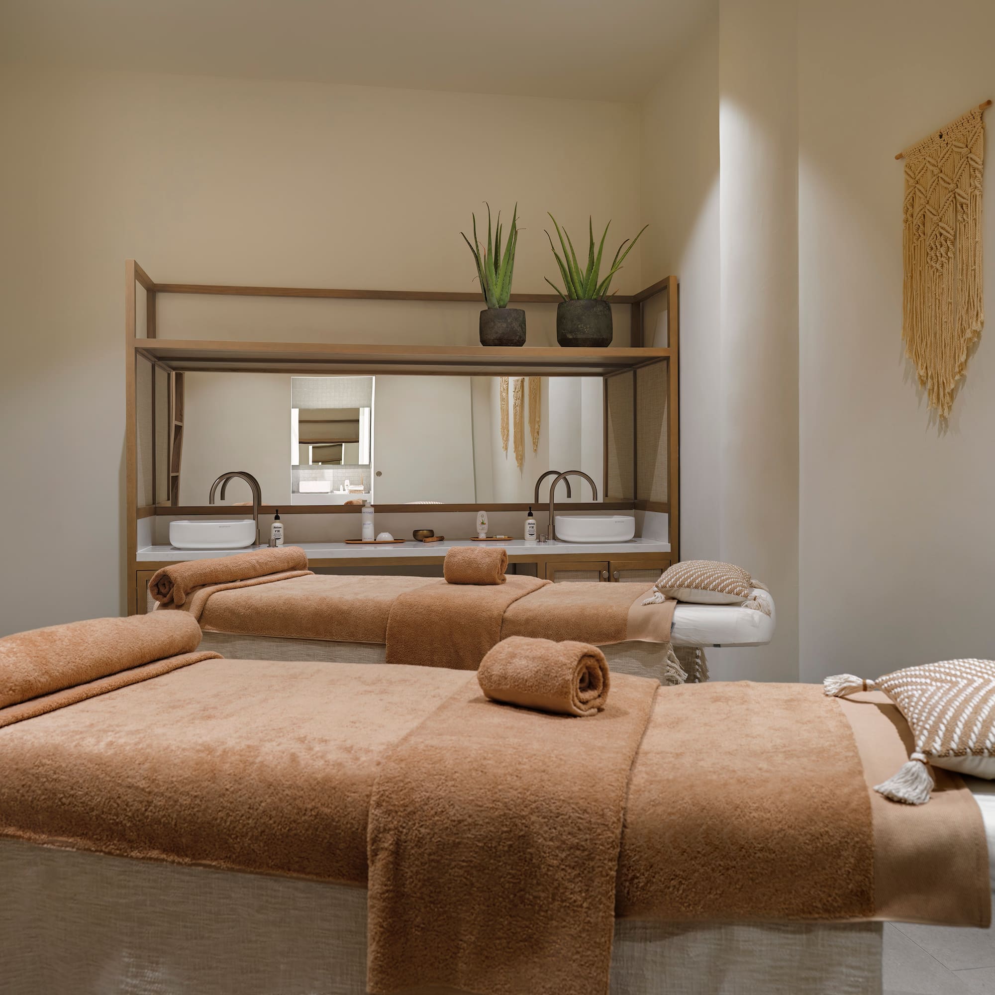 a room with two beds and a mirror