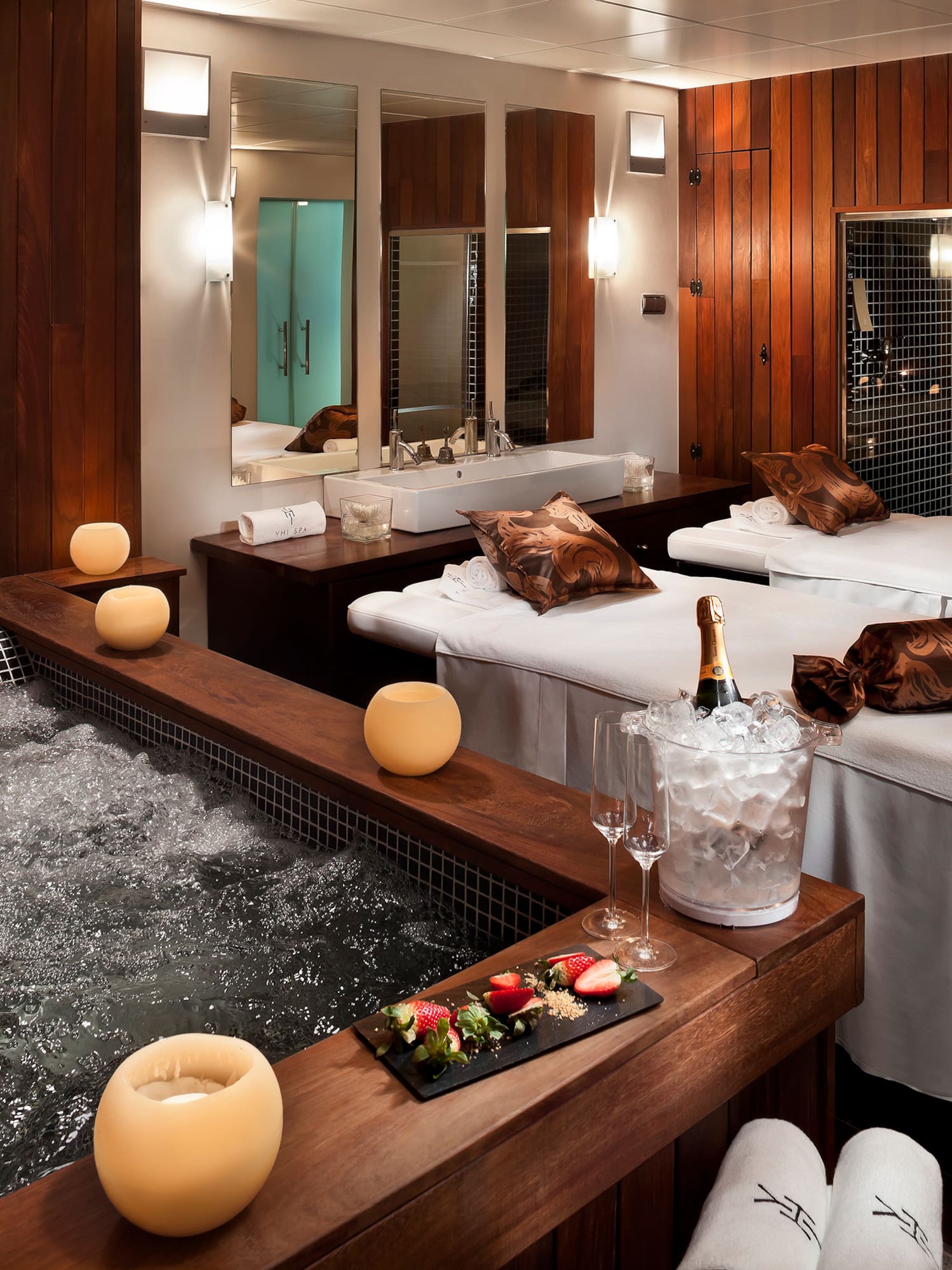 a room with beds and hot tubs