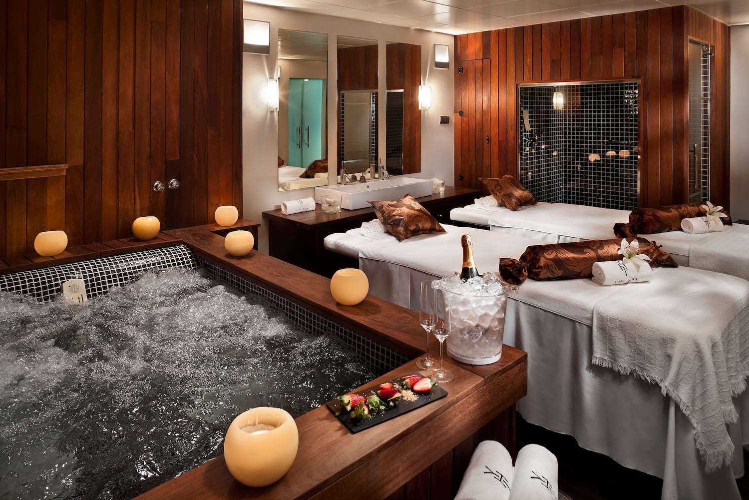 a room with beds and hot tubs