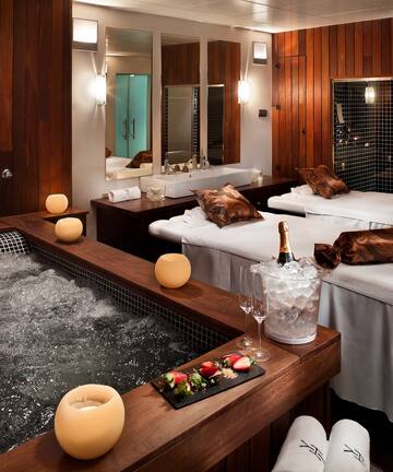 a room with beds and hot tubs