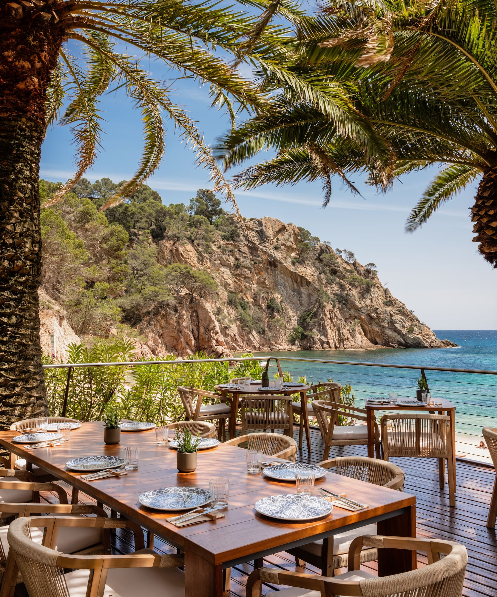 a table and chairs on a deck overlooking a body of water