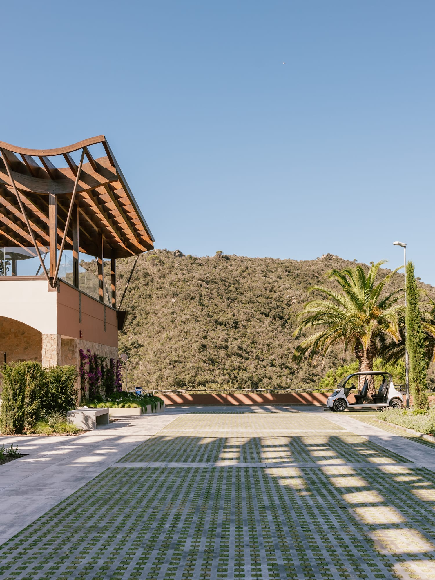 a building with a roof and a car parked in front of it