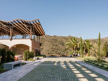 a building with a roof and a car parked in front of it